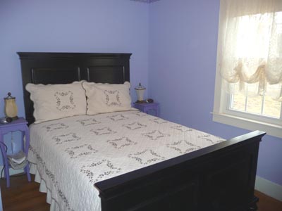 Double bed with nightstands on either side with reading lamps and alarm clocks.